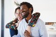© Sam Edwards/Caia Image - Laughing, affectionate multi-ethnic couple looking away