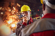 © Caiaimage/Agnieszka Olek/Caia Image - Steelworker talking, using walkie-talkie in steel mill