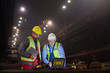 © Caiaimage/Agnieszka Olek/Caia Image - Steelworkers using laptop in dark steel mill