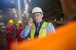 © Caiaimage/Agnieszka Olek/Caia Image - Steelworker supervisor talking on smart phone in steel mill