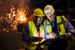 © Caiaimage/Agnieszka Olek/Caia Image - Steelworkers using digital tablets in steel mill