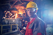 © Caiaimage/Agnieszka Olek/Caia Image - Portrait confident, serious steelworker walkie-talkie in steel mill