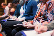 © Tom Merton/Caia Image - Business people taking notes in conference audience