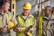 © Caiaimage/Agnieszka Olek/Caia Image - Steelworkers insulated drink container taking coffee break in steel mill