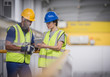 © Martin Barraud/Caia Image - Supervisors with digital tablet talking on platform in factory
