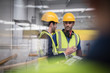 © Martin Barraud/Caia Image - Male supervisor and worker with clipboard talking in factory