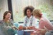 © Caiaimage/Rafal Rodzoch/Caia Image - Smiling women talking in group therapy session