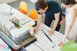 © Robert Daly/Caia Image - Architects drafting blueprint in office