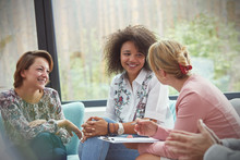 Smiling Women Talking In Group Therapy Session