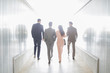 © Caiaimage/Martin Barraud/Caia Image - Business people walking in illuminated office corridor
