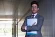 © Caiaimage/Sam Edwards/Caia Image - Portrait serious businessman holding paperwork in office corridor