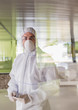 © Caiaimage/Martin Barraud/Caia Image - Portrait serious scientist in clean suit using digital tablet