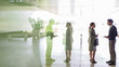 © Caiaimage/Martin Barraud/Caia Image - Business people talking in office lobby