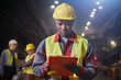 © Caiaimage/Agnieszka Olek/Caia Image - Steelworker with clipboard working in steel mill