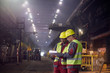 © Caiaimage/Agnieszka Olek/Caia Image - Steelworkers with clipboard meeting in steel mill