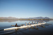 © Richard Johnson/Caia Image - Female rowers rowing scull on sunny lake under blue sky