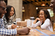 © Sam Edwards/Caia Image - Family playing game at table