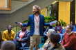 © Martin Barraud/Caia Image - Smiling male speaker with microphone talking to conference audience