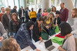 © TomMerton/Caia Image - Business people arriving, checking in at conference registration table