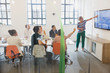 © Sam Edwards/Caia Image - Female architect at television screen leading conference room meeting