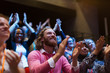 © Sam Edwards/Caia Image - Smiling, enthusiastic man clapping in audience