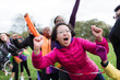 © Sam Edwards/Caia Image - Enthusiastic female spectator cheering at charity run in park