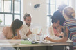 © Sam Edwards/Caia Image - Architects examining model in conference room meeting