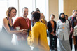 © Martin Barraud/Caia Image - Businesswoman shaking hands with speaker at conference