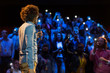 © Martin Barraud/Caia Image - Audience with smart phone flashlights listening to speaker with microphone