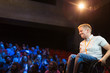 © Sam Edwards/Caia Image - Smiling female speaker in wheelchair on stage
