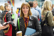 © TomMerton/Caia Image - Portrait smiling, confident businesswoman drinking coffee at conference