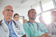 © Rafal Rodzoch/Caia Image - Attentive surgeons, doctors and nurses listening in meeting