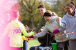 © Sam Edwards/Caia Image - Spectators high-fiving runner at charity run in park