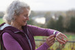 © Tom Merton/Caia Image - Active senior woman exercising, using fitness tracker smart watch