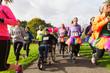 © Chris Ryan/Caia Image - Man in wheelchair among runners at charity race in park