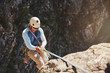 © Trevor Adeline/Caia Image - Male rock climber rappelling, descending from rope