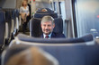 © Agnieszka Olek/Caia Image - Confident businessman on passenger train