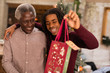 © Sam Edwards/Caia Image - Grandson giving Christmas gift to grandfather