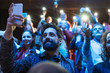 © Sam Edwards/Caia Image - Audience using smart phone flashlights