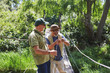 © Trevor Adeline/Caia Image - Active senior men friends fishing on footbridge