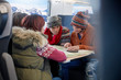 © Agnieszka Olek/Caia Image - Young friends with map planning on passenger train