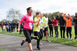 © Sam Edwards/Caia Image - Enthusiastic family runners running in charity run at park