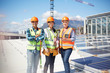 © Trevor Adeline/Caia Image - Portrait confident, smiling engineers at sunny solar power plant