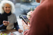 © Tom Merton/Caia Image - Cashier with credit card machine ready for contactless payment