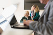 © Martin Barraud/Caia Image - Businesswomen using digital tablet in conference room meeting