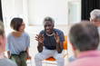 © Martin Barraud/Caia Image - Smiling senior man talking to group in community center