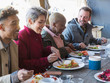 © Chris Ryan/Caia Image - Friends eating breakfast at restaurant outdoor patio