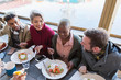 © Chris Ryan/Caia Image - Friends eating breakfast at restaurant