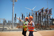 © Trevor Adeline/Caia Image - Female engineers with digital tablet at sunny power plant