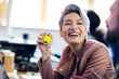 © Robert Daly/Caia Image - Laughing creative businesswoman squeezing stress ball in office